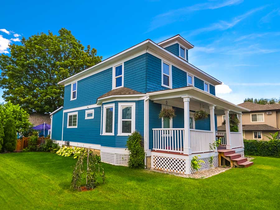 historic-family-house-with-green-lawn-front-blue-sky-background-1